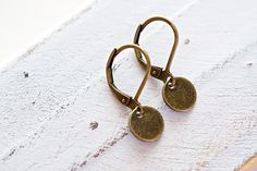 Minimalist Circle Earrings, Dainty Round Drop, Lever Back, Brass Earring. These earrings are great for anyone who likes delicate, light weight jewelry.  - Material: Alloy brass tone lever back earrings and tiny charm. - Size: The approximately length is 3/4 of an inch (20mm). The charm size is 5/16 (8mm) in diameter.  - Quantity: One (1) pair. - Jewelry is shipped in packaging ready for gift giving. Thanks for visiting... Minimalist Brass Earrings With Lever Back Ear Wires, Minimalist Brass Earrings With Lever Back, Earrings Minimal, Giving Thanks, Light Weight Jewelry, Tiny Charm, Earrings Dainty, Brass Earrings, Circle Earrings