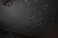 the ceiling is covered with white lights and stars