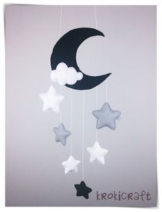 the moon and stars are hanging from strings