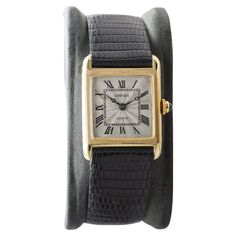 FACTORY / HOUSE: Cartier Watch Company STYLE / REFERENCE: Tank Style / Art Deco METAL / MATERIAL: 18 Kt. Solid Gold CIRCA / YEAR: 1920 / 30's DIMENSIONS / SIZE: Length 30mm X 23mm Width MOVEMENT / CALIBER: Manual Winding / 17 Jewels / European Watch & Clock Co. DIAL / HANDS: Silver Engine Turned / Blued Steel Breguet Style Hands ATTACHMENT / LENGTH: Lizard 17.5mm / Original J.C. Deployant Buckle WARRANTY: 18 months on the movement LIFETIME SERVICE COMMITMENT This is the classic Cartier Tank Watch. It is unique with an engine turned dial. We have only seen a couple of examples of this model with this dial. Remarkably the watch is still fitted with what appears to be the original, and signed Deployant buckle. The movement is signed European Watch & Clock company which was the horological "wi Cartier Tank Watch, Elizabeth Kubler Ross, Factory House, Kubler Ross, Art Deco Metal, Tank Art, Tank Watch, Turn Blue, Watch Clock