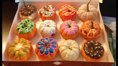 a box filled with lots of different types of doughnuts on top of each other