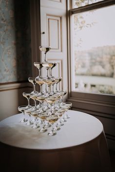 there is a wine glass tower on the table