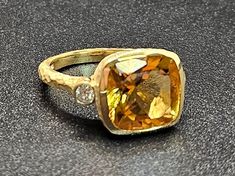 14k solid yellow gold hammered ring with 0.17 ct. SI1 clarity, G color natural brilliant diamonds & 5.80 ct. 11x11 mm cushion shape AAA natural citrine. This item can also be ordered in rose or white gold with different color gemstones such as blue topaz, London blue topaz, amethyst, green amethyst, pink amethyst, smoky quartz, white topaz, garnet, peridot, morganite & aquamarine. Please contact me for a quote as each gemstone varies in price. I am a manufacturer of fine jewelry for over thirty Yellow Gold Citrine Diamond Ring With Accents, Yellow Gold Diamond Ring With Citrine Accents, Yellow Gold Hammered Diamond Rings, Hammered Yellow Gold Diamond Rings, 14k Gold Yellow Rings With Diamond Accents, Yellow 14k Gold Rings With Diamond Accents, Formal Hammered Diamond Jewelry, Gold Topaz Ring With Single Cut Diamonds, 14k Gold Jewelry With Rose Cut Yellow Diamonds