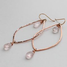 "Delicate and unique, these hand crafted rose gold rose quartz earrings are a beautiful pair to add subtle color to an outfit. We use high quality rose gold fill and natural rose quartz, so these earrings will not change color no matter how much you wear them. Softly glowing rose quartz briolettes are hand wrapped in rose gold fill and suspended from the top and bottom of each handmade leaf hoop. Each rose gold filled hoop is hand shaped, hammered, and polished to a glittering finish. The hammer Glowing Rose, Rose Gold Leaf, Rose Gold Hoop Earrings, Rose Gold Quartz, Handmade Rose, Rose Quartz Earrings, Gold Filled Hoops, Hand Shapes, Quartz Earrings