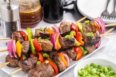 meat and vegetable kabobs on skewers with green onions