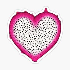 a heart shaped piece of fruit with black dots on the inside and pink in the middle