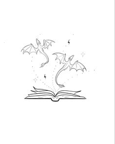 an open book with two bats flying out of it