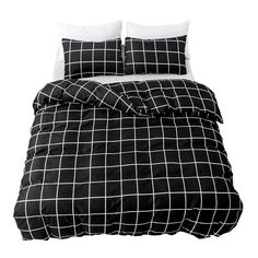 a black and white bed with two pillows on top of the pillowcase, one has a checkered pattern