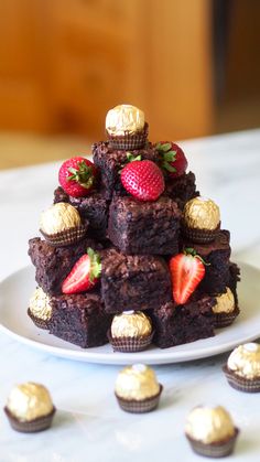 a white plate topped with brownies and strawberries