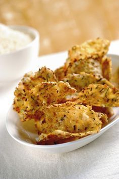 some fried food in a white bowl on a table