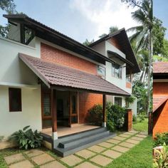 two houses side by side, one has a porch and the other has a patio