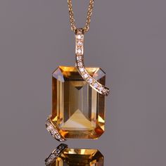 The pendant features a vibrant emerald cut 13.23 carat golden citrine. The gemstone is set within double strap sets of 14k yellow gold accented with white diamonds. This elegant pendant measures at 27.06mm x 13.74mm. Luxury Gemstone Jewelry, Necklace Pendant Ideas, Diamond Bracelet Design, Pearl Necklace Designs, Citrine Jewelry, Citrine Pendant, Classy Jewelry, Jewelry Lookbook, Women's Jewelry And Accessories