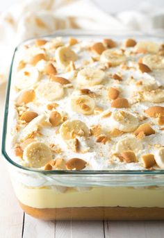 banana pudding in a glass dish on a wooden table