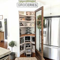 an open pantry in the corner of a kitchen