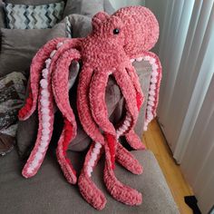 an octopus stuffed animal sitting on top of a couch