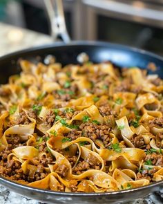 a skillet filled with pasta and ground beef