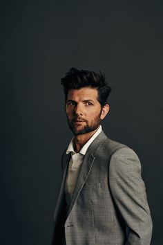 a man in a suit and tie posing for a photo