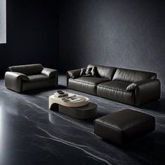 a living room with black walls and leather furniture