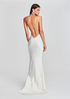 the back of a woman in a white gown