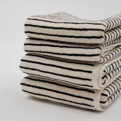 four black and white towels stacked on top of each other