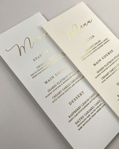 two white and gold menus with the word menu on them, one is for a restaurant