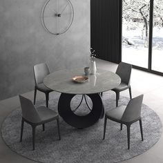 a round table with four chairs and a clock on the wall in front of it