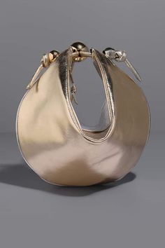 Gold and silver pouch bag in pebble grain texture highlighted by gold plated metallic ball embellishments. - Aza Fashions Metallic Ball, Grain Texture, Buy Gold, Gold Texture, Pouch Bag, Aza Fashion, Handbag Accessories, Gold And Silver, Embellishments