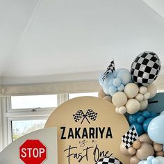 balloons and streamers adorn the entrance to a birthday party at zakarya