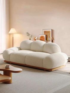 a living room with a white couch and two lamps on the side of the wall