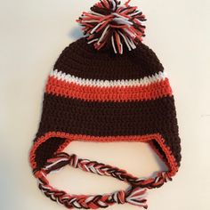 This is a well made, handmade crochet Cleveland Browns Football hat made of acrylic yarn.  This would work for most sizes up to and including adult size.  Laying flat the size of hat width is 19 inches and height of 7.5 inches.  This hat would stretch a little to increase those measurements.  The ear flaps make this hat warmer for those cold days. This is a fun hat, so enjoy !  Quality is important to me. From a smoke-free home. USA made (NE Ohio). Thank you for visiting Cape House Treasures ! Brown Acrylic Yarn Crochet Beanie Hat, Brown Acrylic Yarn Crochet Beanie, Brown Outdoor Crochet Hat, Brown Crochet Cap, Cleveland Browns Football, Browns Football, Handmade Beanies, Sport Hat, Warm Winter Hats