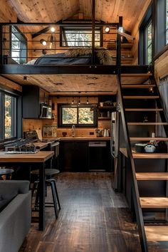 a loft with stairs leading up to the kitchen