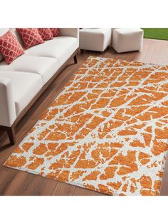 an orange and white area rug in a living room