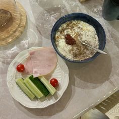 a table topped with plates and bowls filled with different types of food on top of it