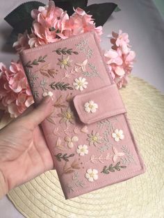 This hand embroidered wallet is beautifully made from linen. Featuring wild flower, botanical greenery embroidered. There are two color pink or black fabric you can select it. There are 12 card slots. Magnatic button. This wallet is perfect gift for her, gift for mom, best friend gift,  graduation gift, Christmas gift  Approximately 18 × 10 cm  Perfect size for cash and cards.  Actual color may be slightly different due to lighting. Embroidered Wallet, Mom Best Friend, Fabric Wallet, Embroidered Gifts, Embroidery Bags, Handcrafted Accessories, Gift Graduation, Money Clip Wallet, Perfect Gift For Her