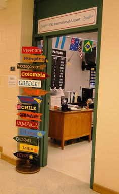 an open door with many different signs on the front and side of it in a hallway