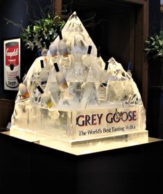 an ice sculpture in the shape of a pyramid with grey goose vodka bottles on top