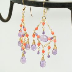 "Pink Amethyst and Coral Chandelier Earrings in Gold Filled Beautiful Natural Pink Amethyst Briolettes are wrapped with high quality 14k gold filled wire and swing from a gold filled bar chains. The crown of the earrings are two large amazingly clear Pink Amethyst briolettes which dangle at the bottom and combined with coral beads, to create a unique and unusual look. The combination of amethyst and coral beads creates a unique look, which makes these a stunning statement earrings! Perfect for s Purple Dangle Earrings With Gemstone Accents, Purple Gemstone Accented Dangle Earrings, Purple Gemstone Dangle Earrings, Purple Handmade Fine Jewelry Earrings, Purple Gemstone Chandelier Earrings For Gift, Amethyst Dangle Earrings Fine Jewelry, Fine Jewelry Amethyst Dangle Earrings, Purple Dangle Earrings Fine Jewelry, Purple Amethyst Gemstone Chandelier Earrings