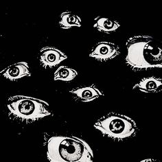 an image of many eyes in the dark