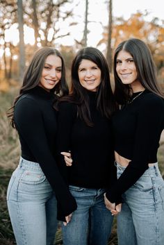 three women standing next to each other with their arms around one another and smiling at the camera