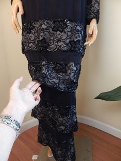 Fred hayman, wilshire blvd los angles black beaded gown in excellent condition, 100 percent silk silk sheer bodice and sheer sleeves beaded collar and cuffs amazing dress excellent condition pads in bust back zipper hooks and eyes at choker neck 36 bust 32 waist 43 hip 50 length three tiers of skirt, all beaded and scalloped Fitted Mother Of The Bride Dress With Sheer Sleeves, Silk Evening Gown With Sheer Sleeves, Fitted Beaded Evening Gown, Sheer Fitted Evening Dress For Mother Of The Bride, Fitted Beaded Gown For Evening, Sheer Mother Of The Bride Dress For Evening, Beaded Fitted Maxi Dress For Evening, Fitted Beaded Maxi Dress For Evening, Fitted Beaded Evening Dress