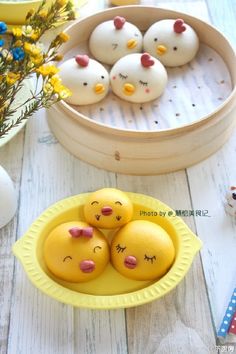 there are some little chicks in a yellow bowl on the table next to other decorations