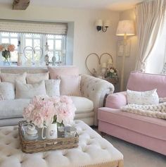 a living room filled with lots of furniture and flowers on top of a coffee table