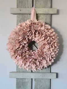 a wreath hanging on the side of a wooden door