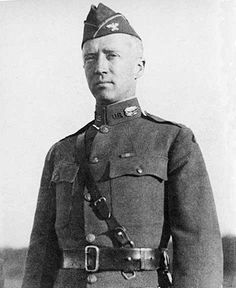 an old black and white photo of a man in uniform