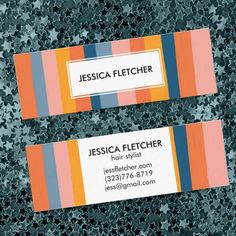 two business cards sitting on top of each other with different colors and designs in them