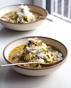 two bowls filled with soup on top of a table