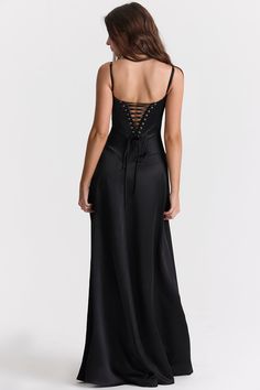 'Anabella' is perhaps our most elegant dress yet and the epitome of black tie dressing. Cut from a luxurious black silky satin for a fluid drape, 'Anabella' features a built in bra that's underwired for a flattering bust with delicate rouleau shoulder straps.The bodice has a curved hem that sits below the natural waistline and we're loving the corset inspired lace up back for a vintage feel. The skirt skims over the hips, falling freely to the floor and 'Anabella' would not be complete without tonal heels like our 'Paris' in black suede for glamorous events. The 'Regular Cup' option suits cup size A-C whilst the 'Bigger Cup' option suits cup size D-E.No bra required as it's cupped and lined.Made from heavy silky satin.Stretch Factor: 2/3 Corset Dresses Vintage Prom, Corset Dress Vintage, Witchy Birthday, Corset Back Dress, Corset Maxi Dress, Lace Corset Dress, Corset Dresses, Vintage Prom, Witchy Fashion