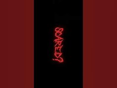 the back side of a cell phone case with red neon text on it and a black background