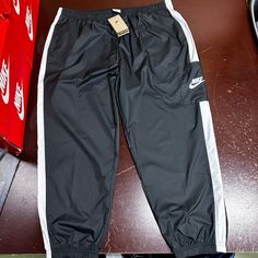 Nike Womens Black Sportswear Standard Fit Mid Rise Woven Track Pants Size Xxl Brand: Nike Department: Womens Size: Xxl Color: Black Type: Pants Style: Track Pants Pattern: Solid Theme: Sports Occasion: Activewear Season: All Season Features: Elastic Waist, Pockets Condition: New With Tags I Offer Discounts For All Return Customers. - Jvs Black Sportswear Bottoms For Gym, Athleisure Black Joggers With Elastic Waistband, Black Moisture-wicking Sportswear Bottoms, Black Athleisure Joggers With Elastic Waistband, Black Sportswear Bottoms For Jogging, Black Sportswear Sweatpants For Workout, Casual Nylon Tracksuit For Streetwear, Black Moisture-wicking Pants For Loungewear, Black Nylon Sweatpants With Side Pockets