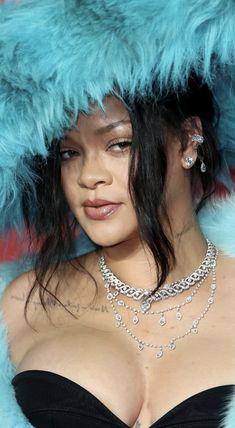 a close up of a person wearing a fur coat and jewelry on her head,